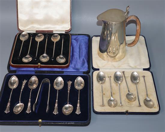 Three cased sets of silver teaspoons and a silver hot water pot.